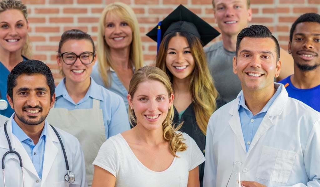 A group of professionals smiling from different careers